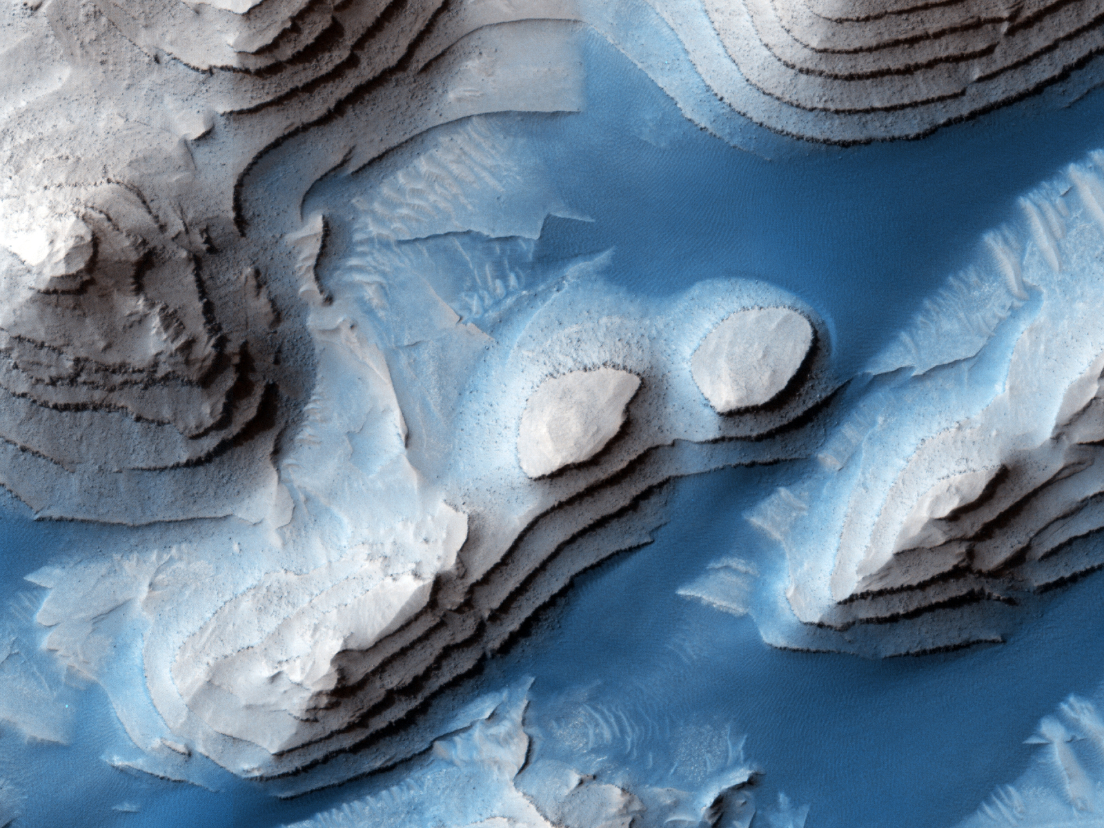 topographical image of the surface of mars. shows layers of land embedded in ice.