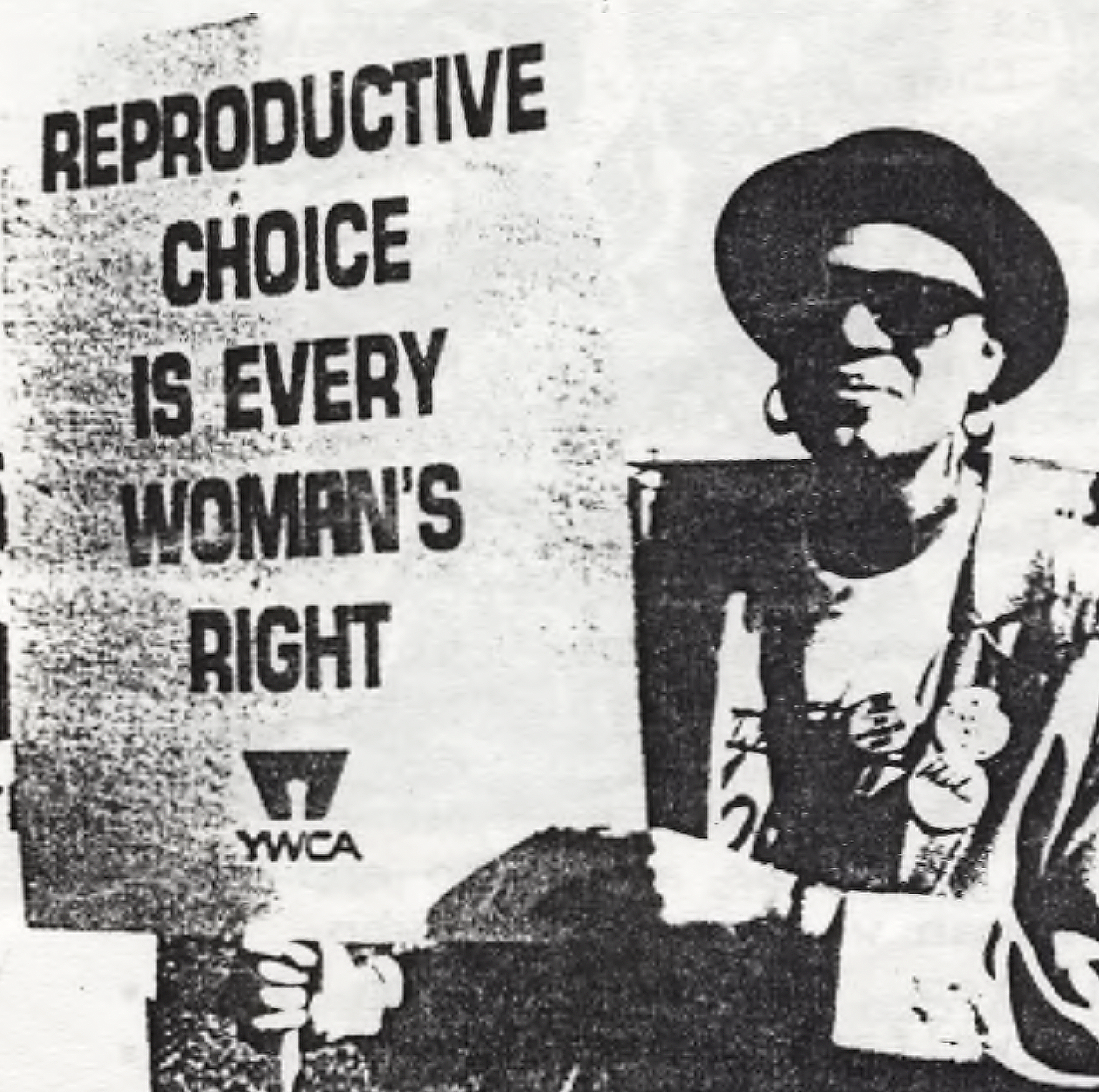 Black and White image of a woman holding a sign reading Reproductive Choice is Every Woman's Right