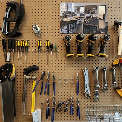 image of hand tools hanging from pegboard