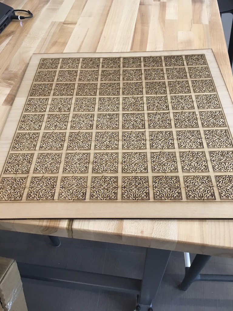 The chess board, after laser cutting is completed, but before color is painted on.