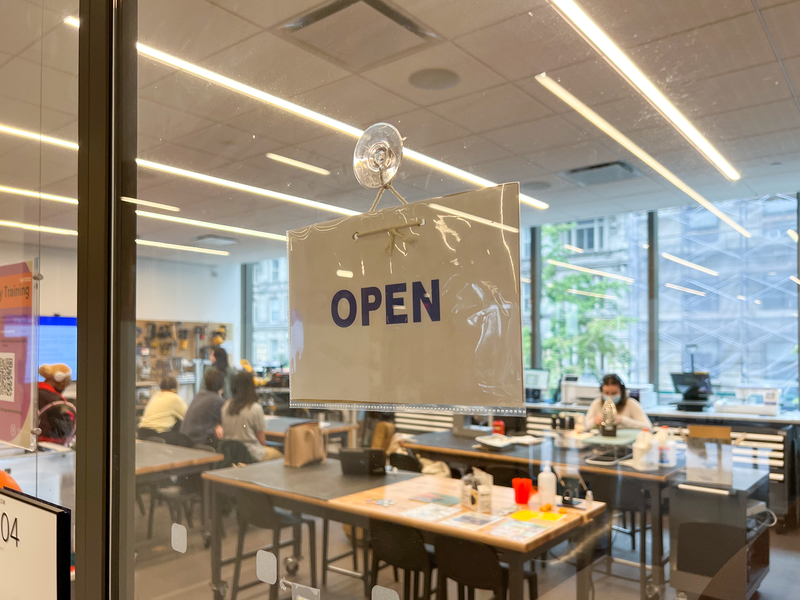 photo of sign hanging in design center window that reads 'open'